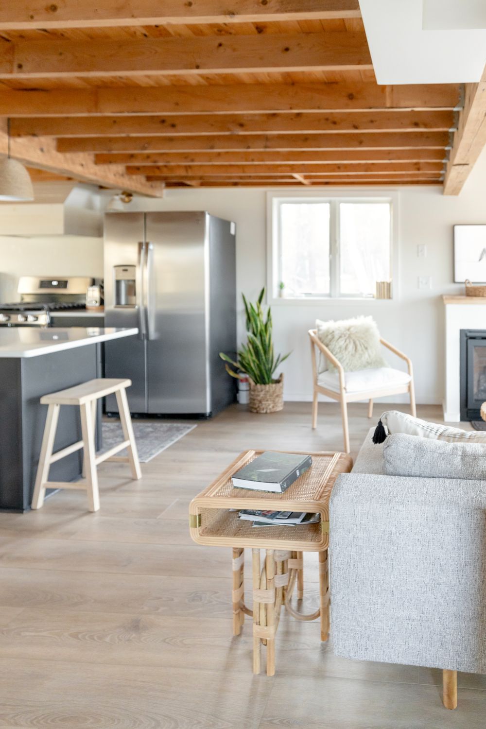 Bright open living and kitchen space with a timber chair