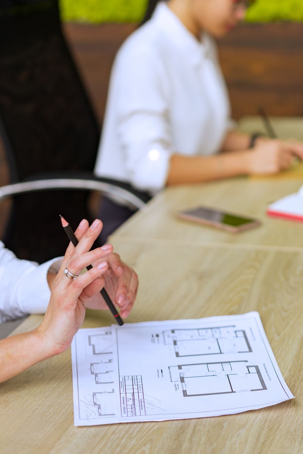 Architect analysing a floor plan with a pencil