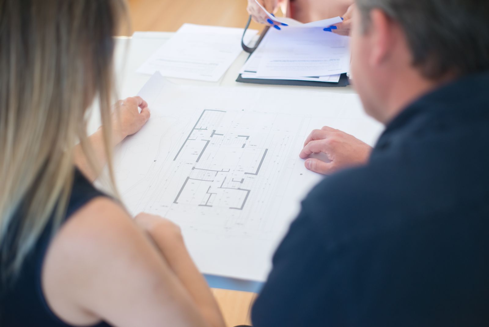 Detailed floor plan being discussed at the design studio